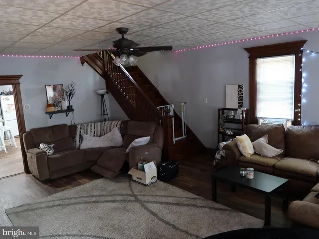 a living room with lots of furniture and gym equipment
