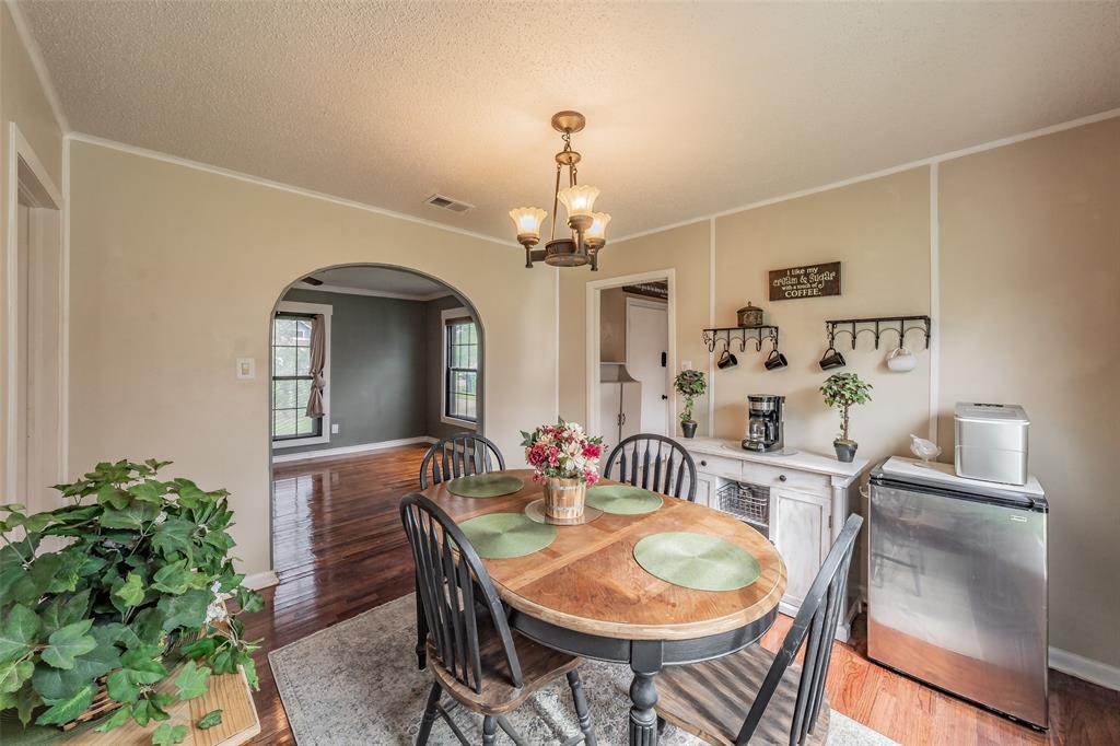 1802 Keneipp Road Carrollton, TX 75006 - Photo 7 of 22 This room features hardwood flooring, an arched doorway, and a ceiling light fixture