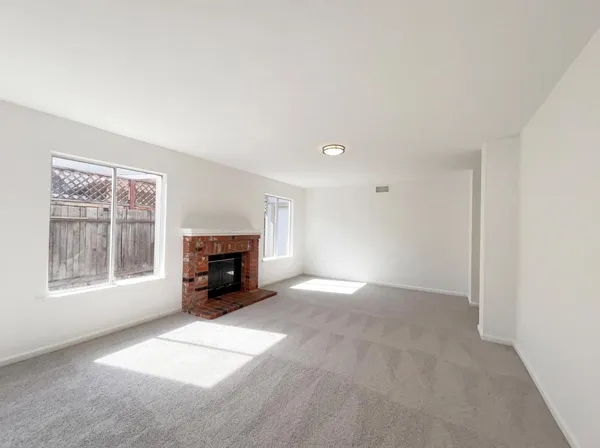 a view of empty room with a fireplace