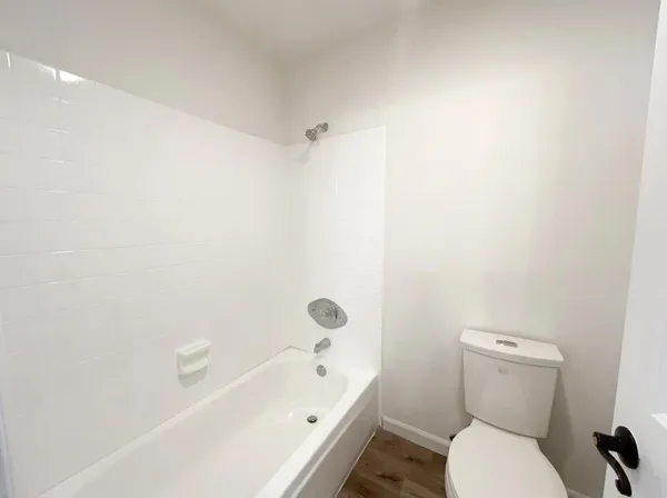 a bathroom with a toilet and a bath tub