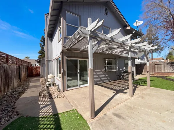 a view of a patio with table and chairs with wooden floor and fence