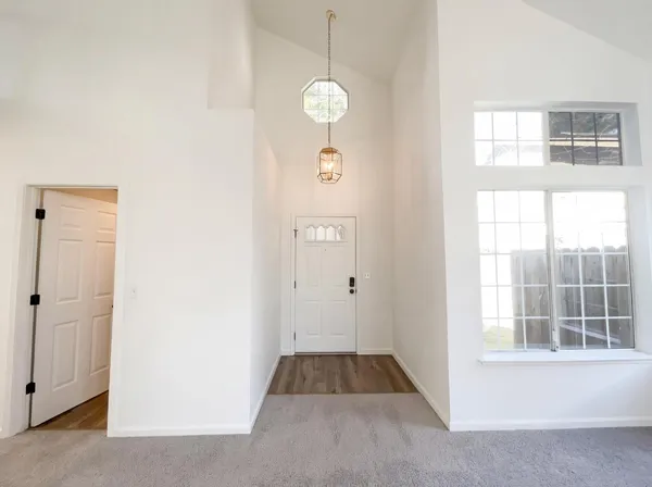 a view of an entryway with wooden floor and windows