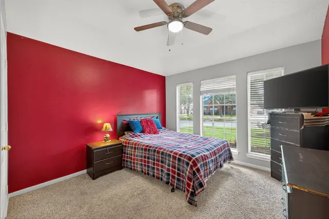 a bedroom with a bed and a flat screen tv