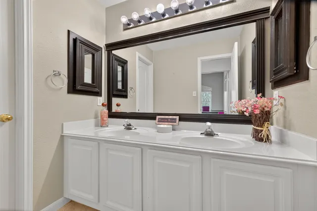 a bathroom with a sink vanity and a mirror