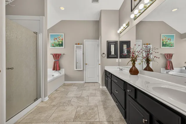 a large bathroom with a sink double vanity and shower