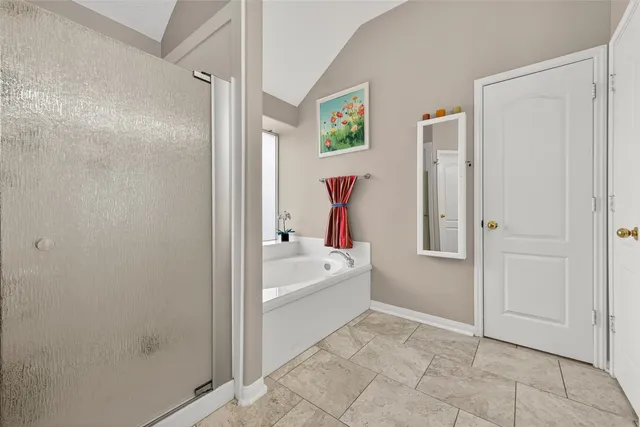 a bathroom with a bathtub and shower