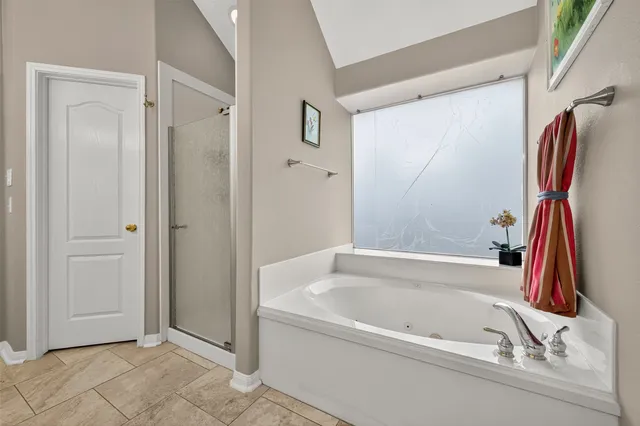 a white bath tub sitting next to a shower