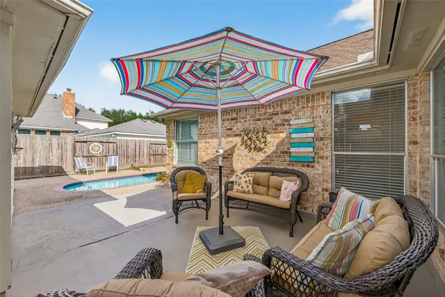 a view of a patio with couches chairs and a potted plant