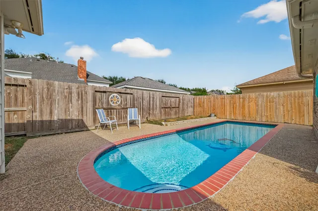 swimming pool view with a tub and wooden floor