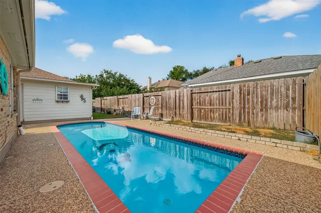 a view of a balcony with swimming pool and furniture