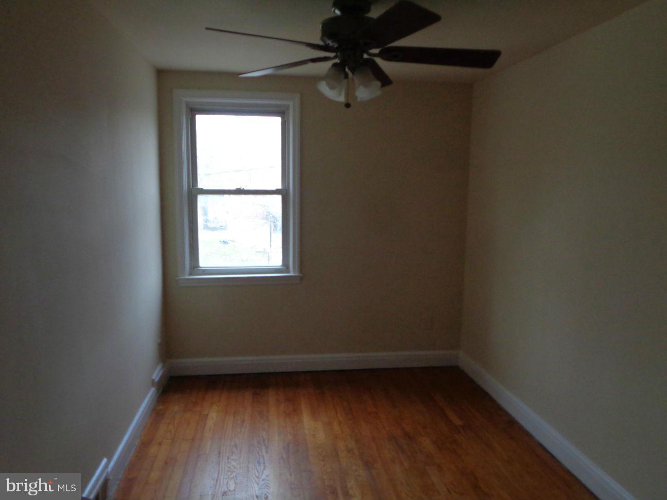 827 Wedgewood Road Baltimore, MD 21229 - Photo 11 of 22 a view of a small space with wooden floor and a window