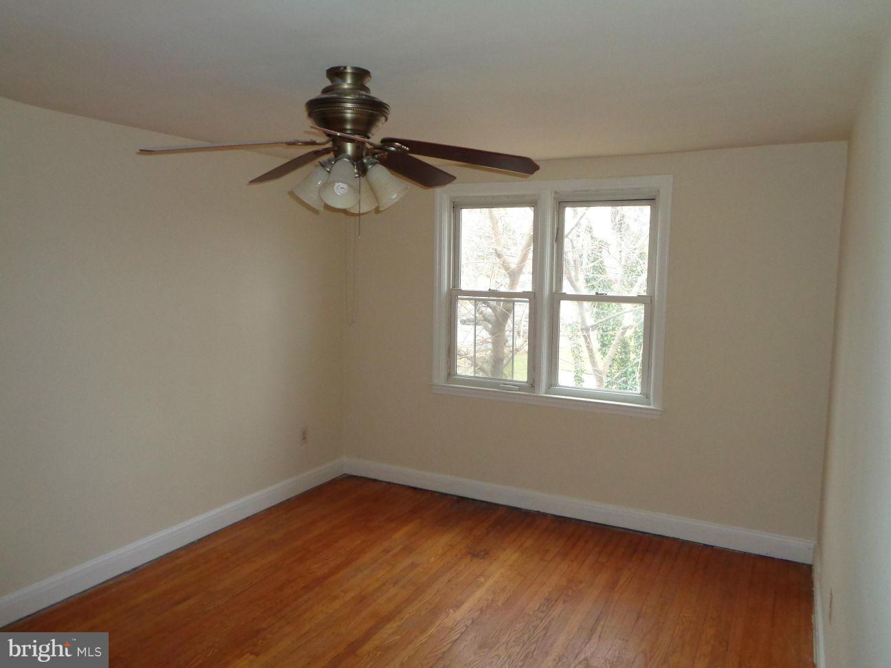 827 Wedgewood Road Baltimore, MD 21229 - Photo 12 of 22 wooden floor in an empty room with a window