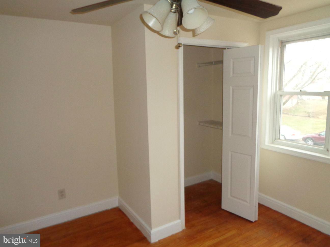 827 Wedgewood Road Baltimore, MD 21229 - Photo 16 of 22 a view of an empty room with wooden floor and a window