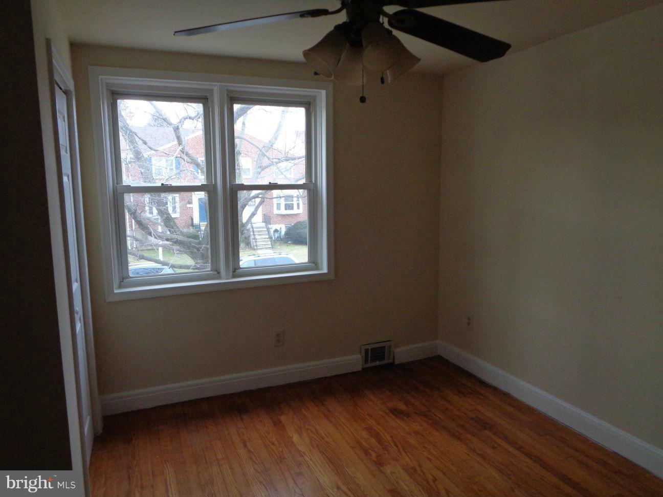 827 Wedgewood Road Baltimore, MD 21229 - Photo 17 of 22 an empty room with wooden floor and windows