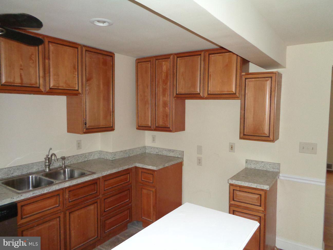 827 Wedgewood Road Baltimore, MD 21229 - Photo 4 of 22 a kitchen with stainless steel appliances granite countertop a sink stove and cabinets