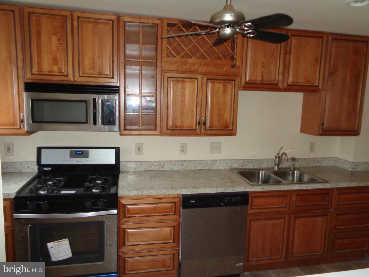827 Wedgewood Road Baltimore, MD 21229 - Photo 5 of 22 a kitchen with granite countertop a sink stainless steel appliances and cabinets