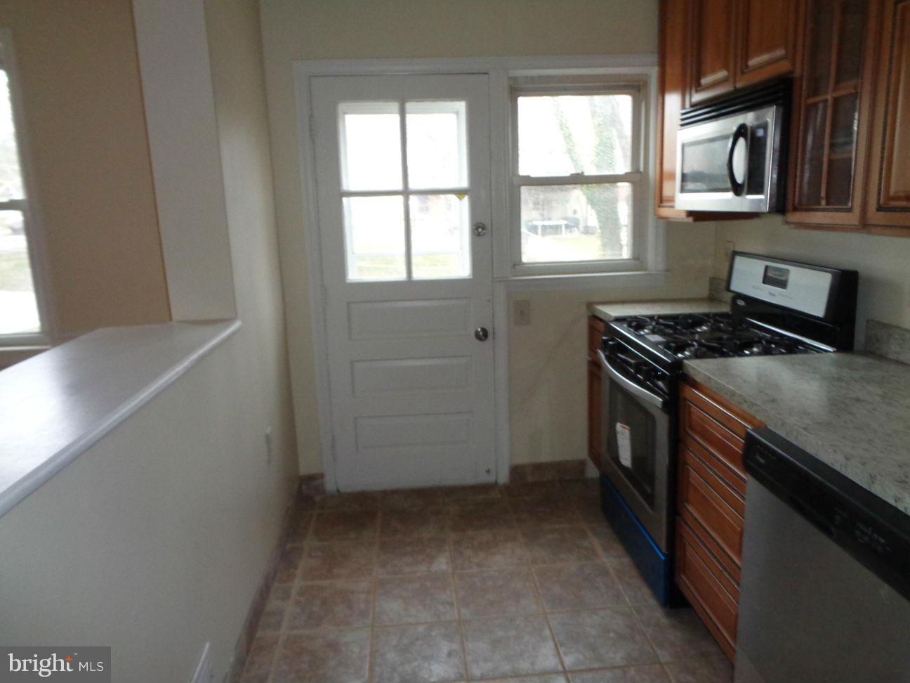 827 Wedgewood Road Baltimore, MD 21229 - Photo 6 of 22 a kitchen with a stove and a microwave