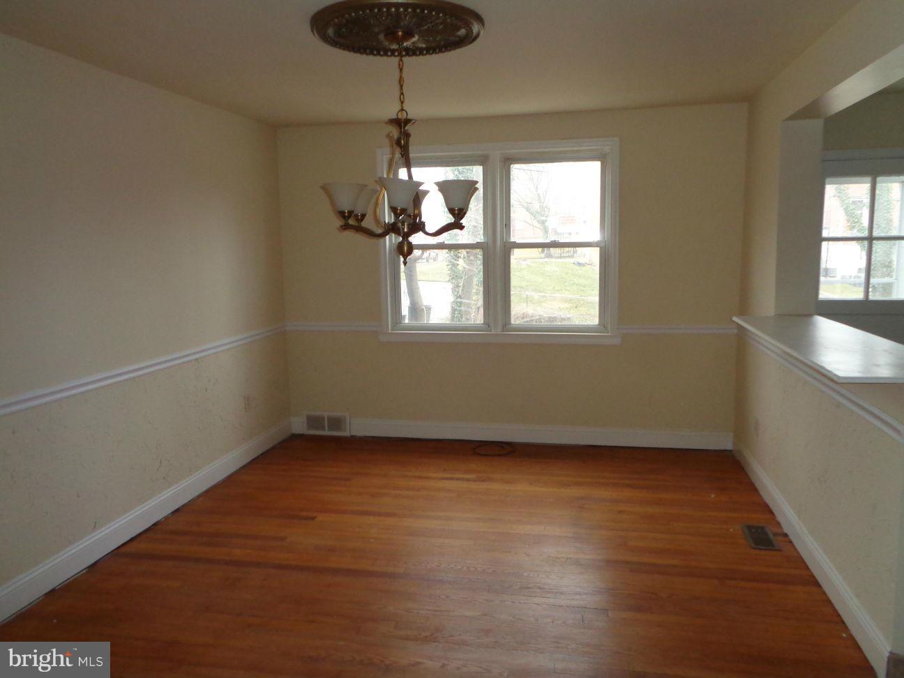 827 Wedgewood Road Baltimore, MD 21229 - Photo 7 of 22 wooden floor in an empty room with a window