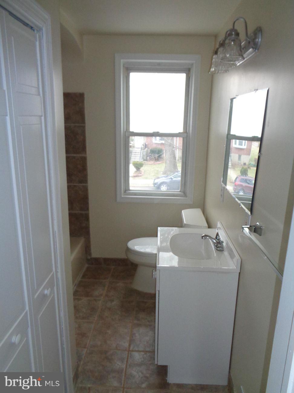 827 Wedgewood Road Baltimore, MD 21229 - Photo 9 of 22 a bathroom with a sink toilet and tub