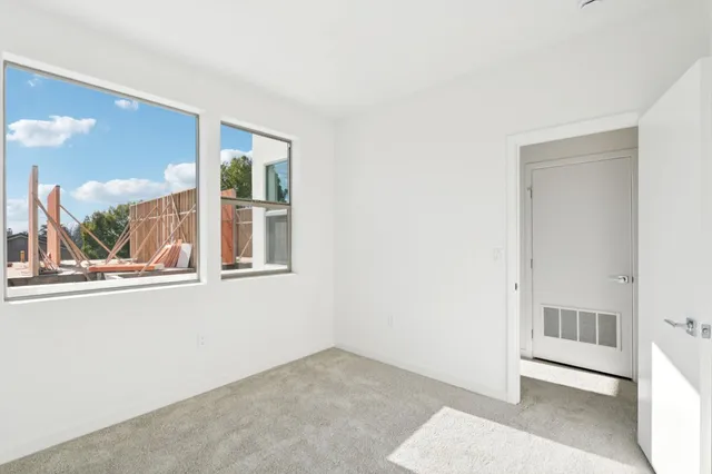 an empty room with a large window and mirror