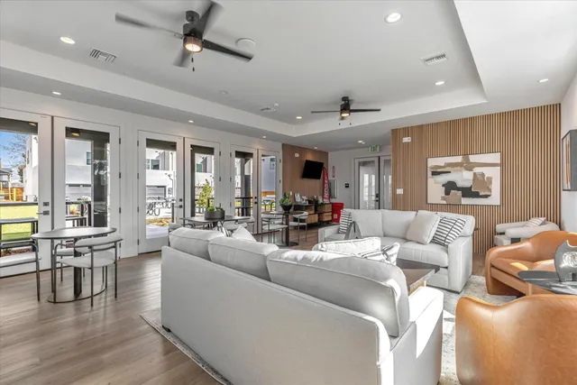 a living room with furniture and wooden floor