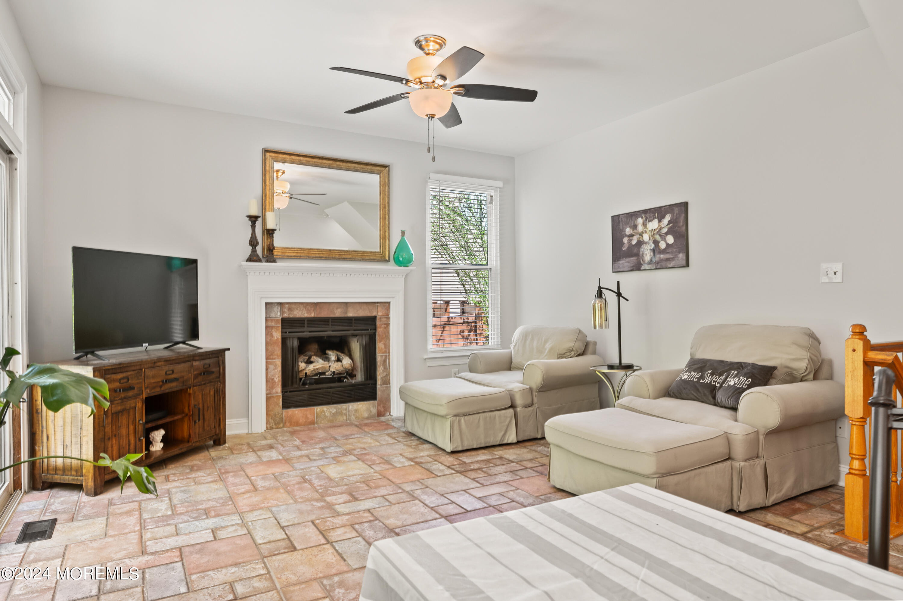 52 Danella Way Howell, NJ 07731 - Photo 11 of 42 a living room with couches a fireplace and a flat screen tv