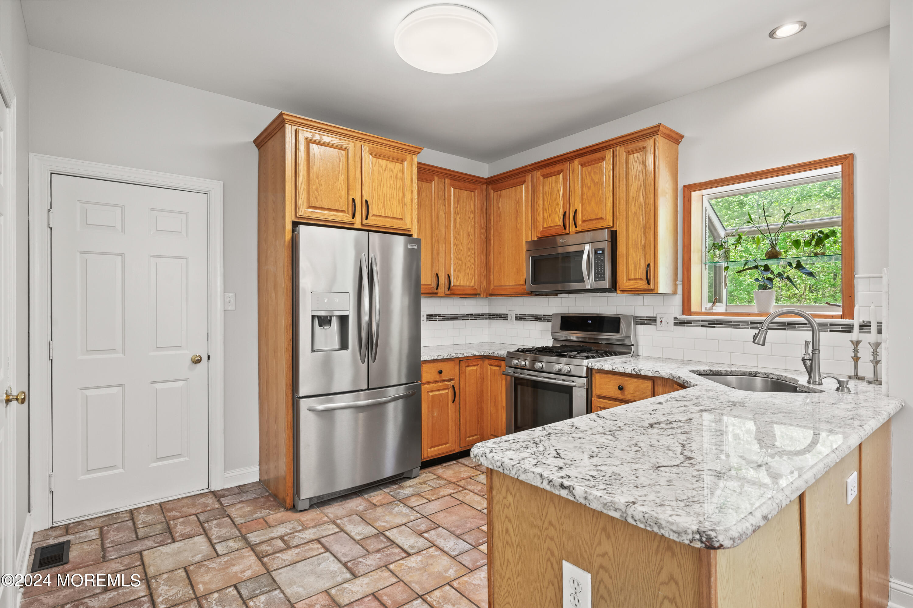 52 Danella Way Howell, NJ 07731 - Photo 17 of 42 a kitchen with granite countertop a refrigerator oven a sink dishwasher and a stove with granite countertops