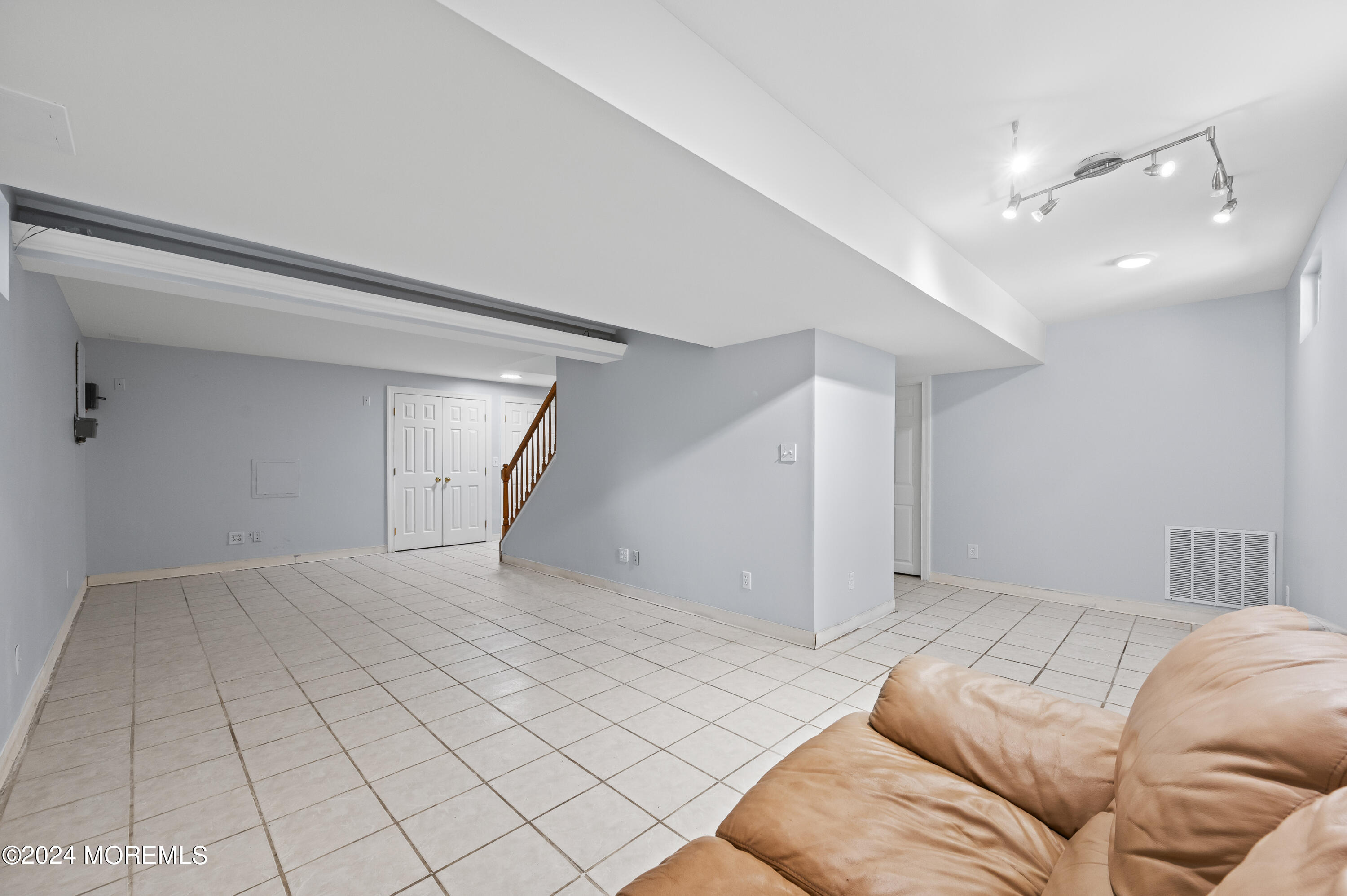 52 Danella Way Howell, NJ 07731 - Photo 30 of 42 a bedroom with a large bed and a chandelier