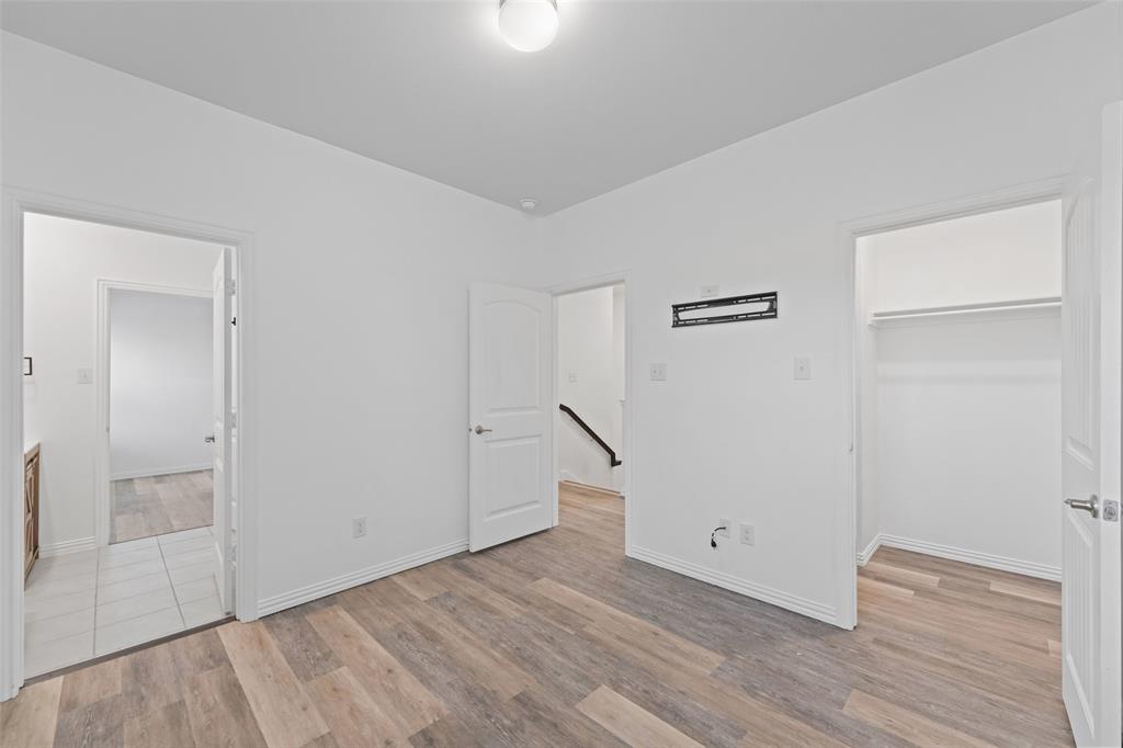 4651 Raleigh Dalton Road Dallas, TX 75227 - Photo 14 of 19 Wood-finish flooring with crisp white walls and ceiling