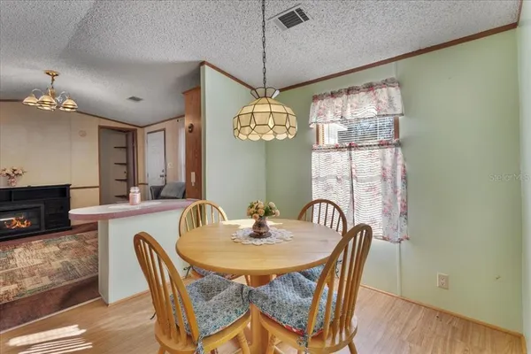 a dining room with furniture a chandelier and window