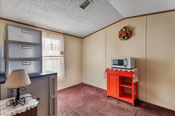 a view of kitchen with furniture and a window