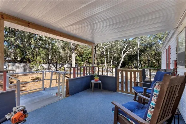 a balcony with furniture and wooden floor