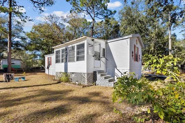 a view of a house with a yard and plant
