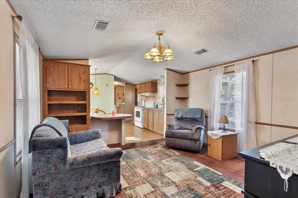 a living room with furniture or couch and a chandelier