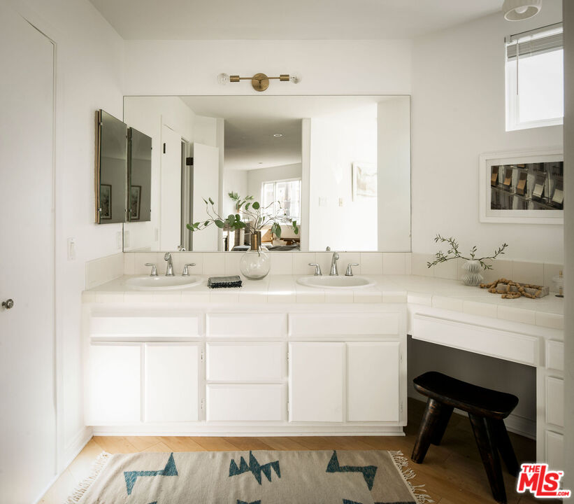 1014 9th Street, Unit 4 Santa Monica, CA 90403 - Photo 23 of 38 a bathroom with a sink and a mirror