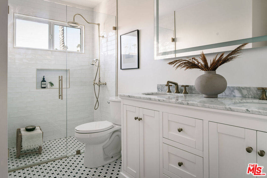 1014 9th Street, Unit 4 Santa Monica, CA 90403 - Photo 28 of 38 a bathroom with a granite countertop sink toilet and shower