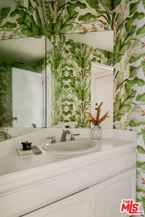 1014 9th Street, Unit 4 Santa Monica, CA 90403 - Photo 35 of 38 a bathroom with a sink and mirror