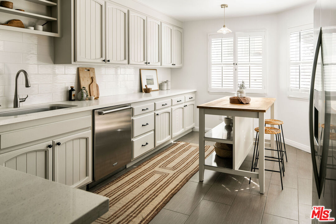 1014 9th Street, Unit 4 Santa Monica, CA 90403 - Photo 6 of 38 a kitchen with stainless steel appliances granite countertop a sink and a refrigerator