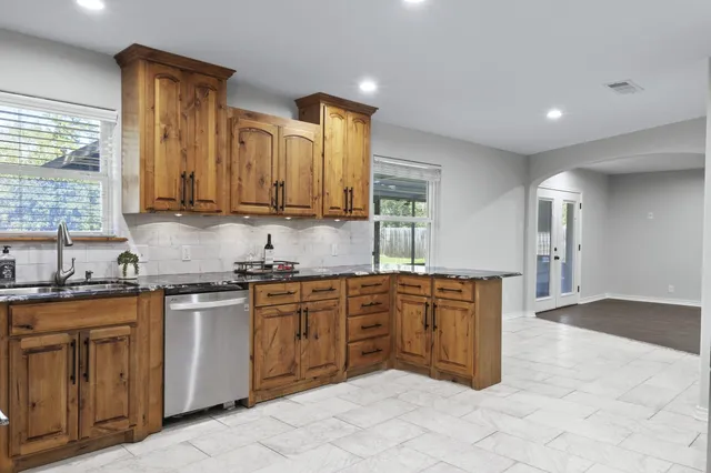 a kitchen with stainless steel appliances a refrigerator sink and cabinets