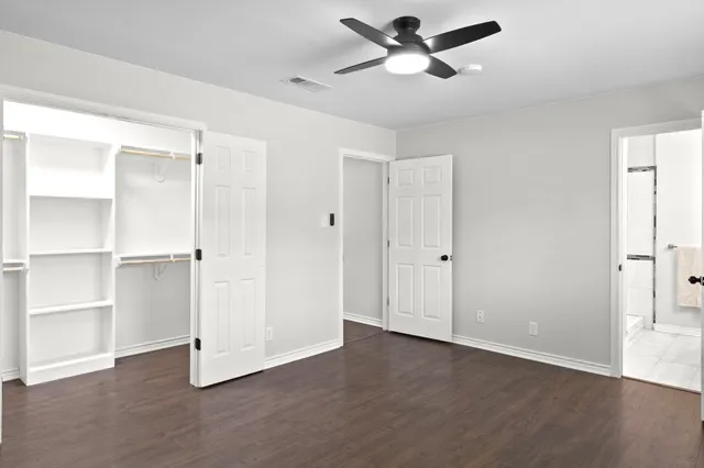 a bathroom with a granite countertop sink a toilet and a mirror