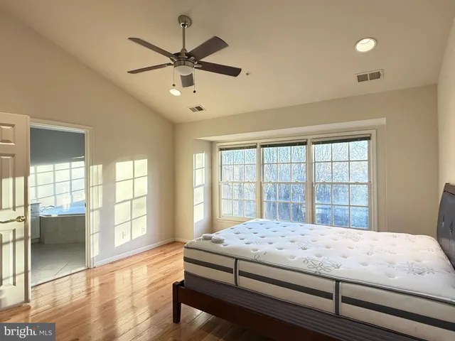 a bedroom with a large bed and a large window