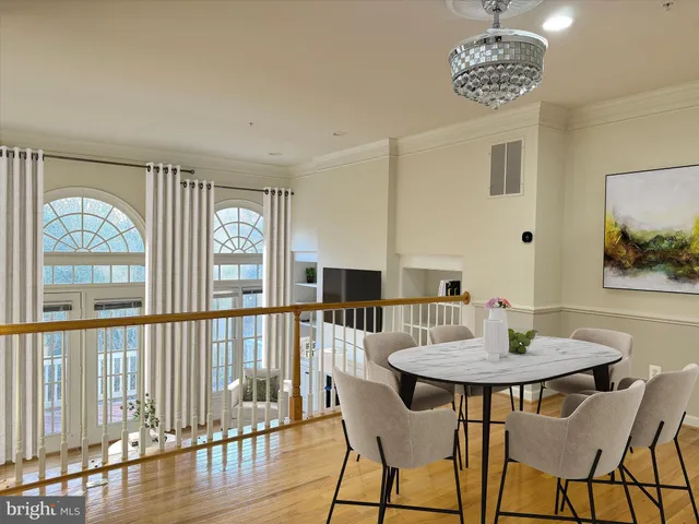 a view of a dining room with furniture wooden floor and a chandelier