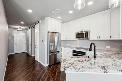 a kitchen with stainless steel appliances granite countertop a refrigerator and a sink