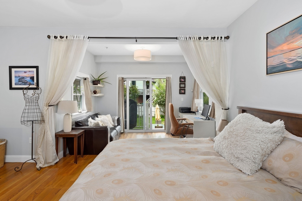 299 Sumner Street, Unit 1 Boston, MA 02128 - Photo 13 of 23 a bedroom with furniture and large windows