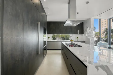 a living room with stainless steel appliances kitchen island granite countertop furniture and a kitchen view