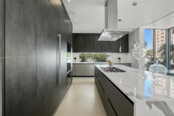 a living room with stainless steel appliances kitchen island granite countertop furniture and a kitchen view