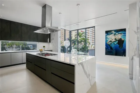 a kitchen with stainless steel appliances a sink and cabinets