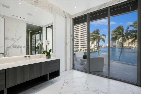 a large white kitchen with a large window