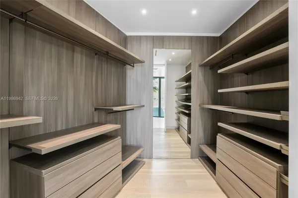 a bed room with a bed mirror and a window