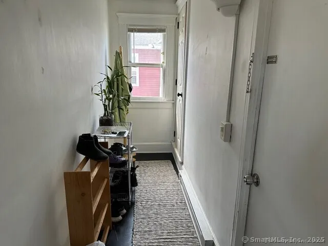 a view of a hallway with wooden floor
